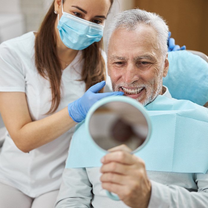 An aging gentleman happy with his new dental implant