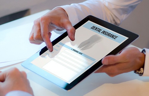Patient reviewing dental insurance form in office