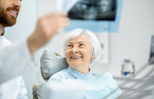 Dentist reviewing a dental X-ray with patient