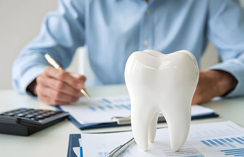 Man budgeting for the cost of dental care