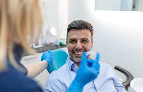 Smiling man at Invisalign check-in appointment