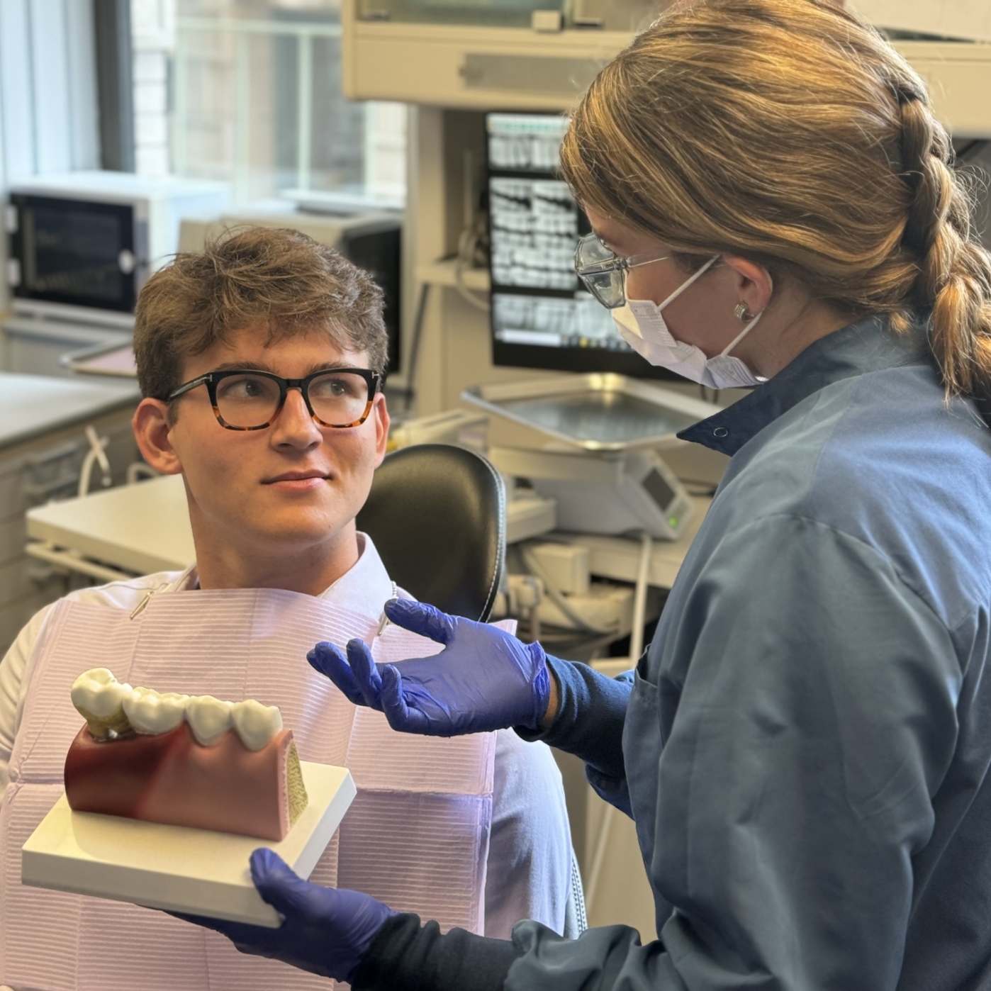 Worried woman at dental office covering her mouth