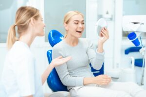 Woman admiring her permanent veneers after placement