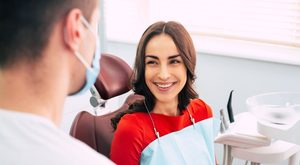 Happy patient speaking with her dentist
